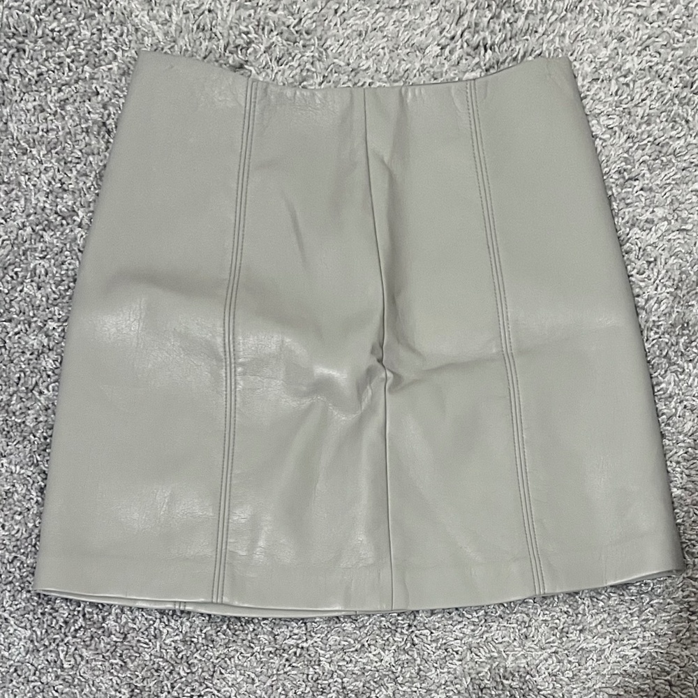 Aritzia vegan leather skirt, Size 4, in cream, and has never been worn.